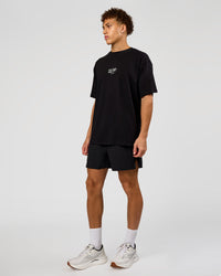 Man wearing Run Club Script FLXCotton Oversized Tee - Black-Alloy | Model:Leandro | Size:M