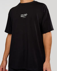 Man wearing Run Club Script FLXCotton Oversized Tee - Black-Alloy | Model:Leandro | Size:M