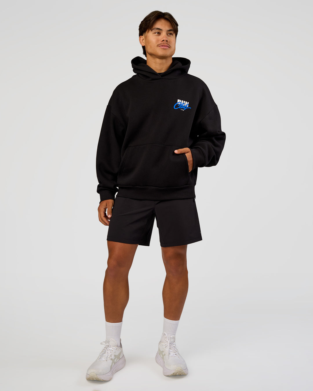 Man wearing Run Club Script Oversized Hoodie - Black-Palace Blue | Model:George | Size:M