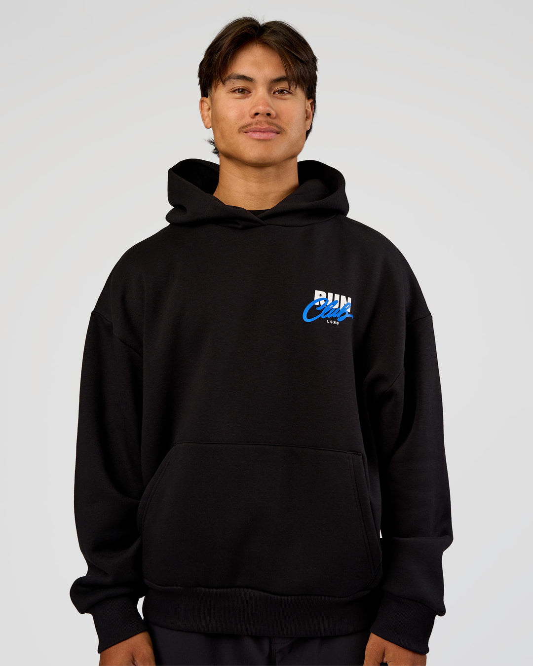 Man wearing Run Club Script Oversized Hoodie - Black-Palace Blue | Model:George | Size:M