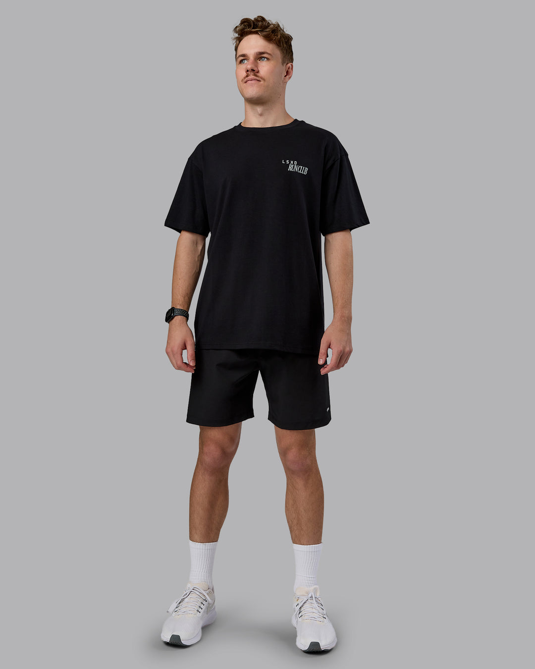 Man wearing Run Love FLXCotton Oversized Tee - Black-Reflective | Model:Cameron | Size:M
