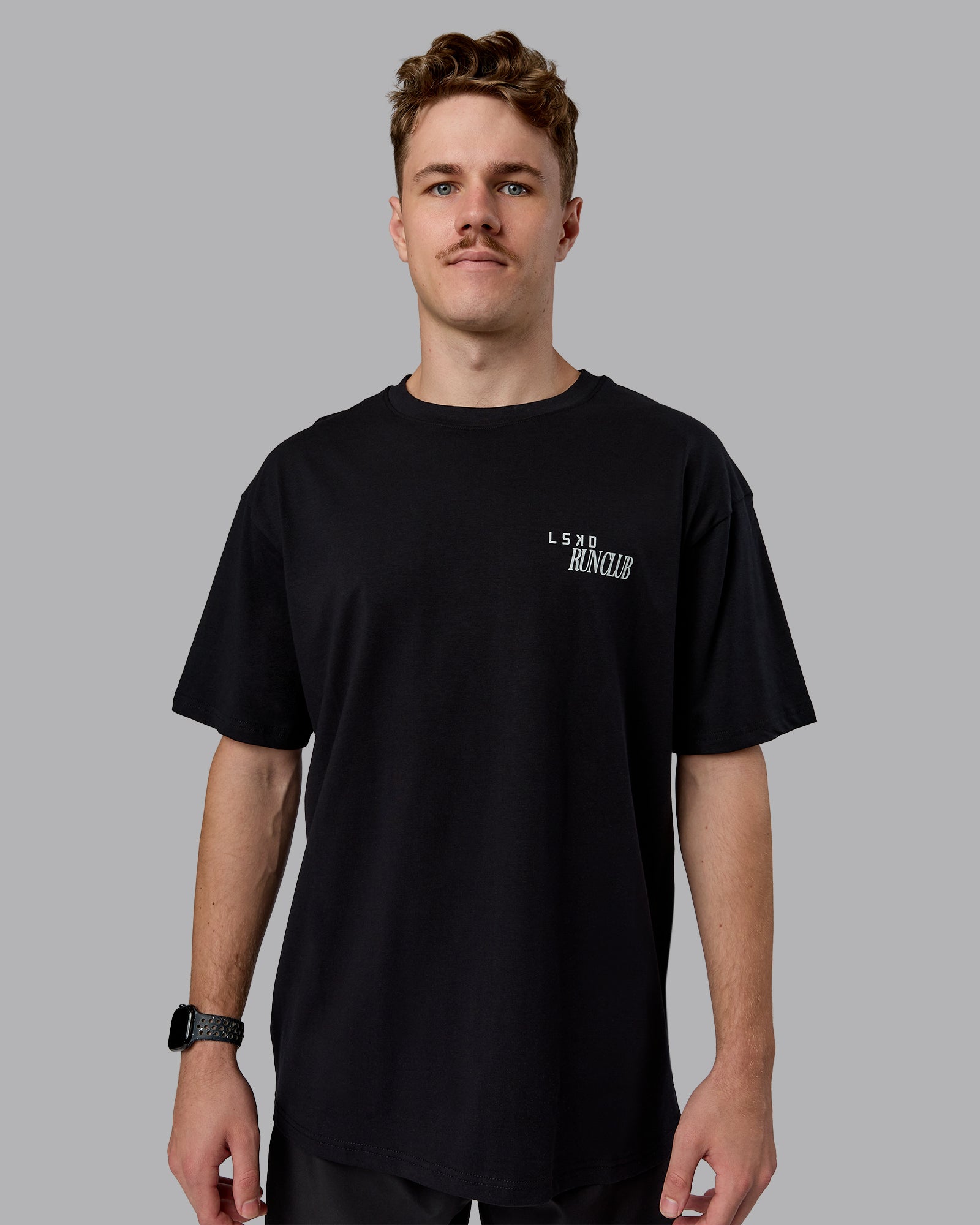 Man wearing Run Love FLXCotton Oversized Tee - Black-Reflective | Model:Cameron | Size:M