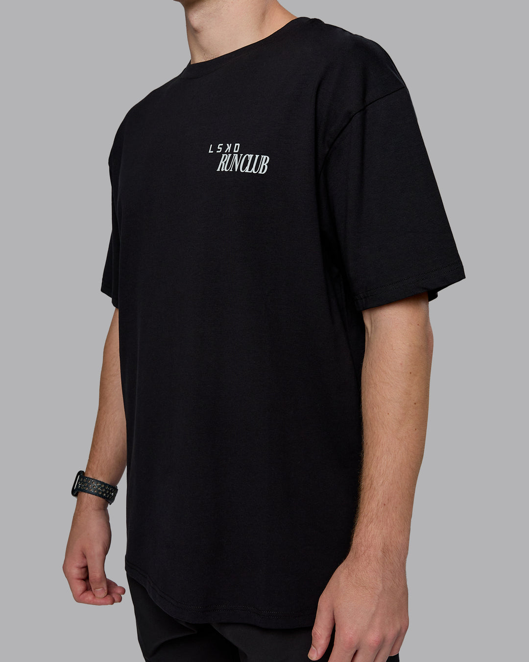 Man wearing Run Love FLXCotton Oversized Tee - Black-Reflective | Model:Cameron | Size:M
