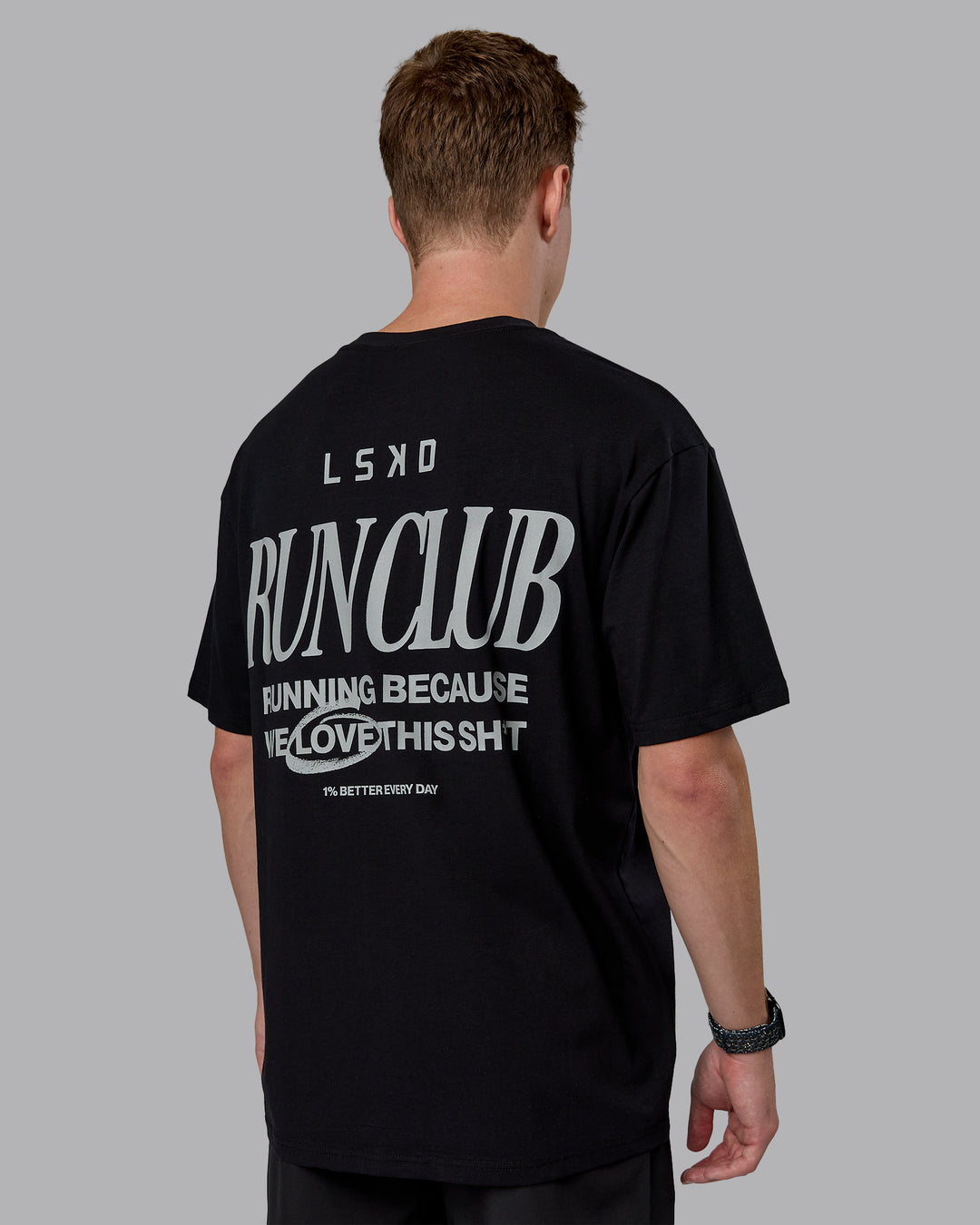 Man wearing Run Love FLXCotton Oversized Tee - Black-Reflective | Model:Cameron | Size:M
