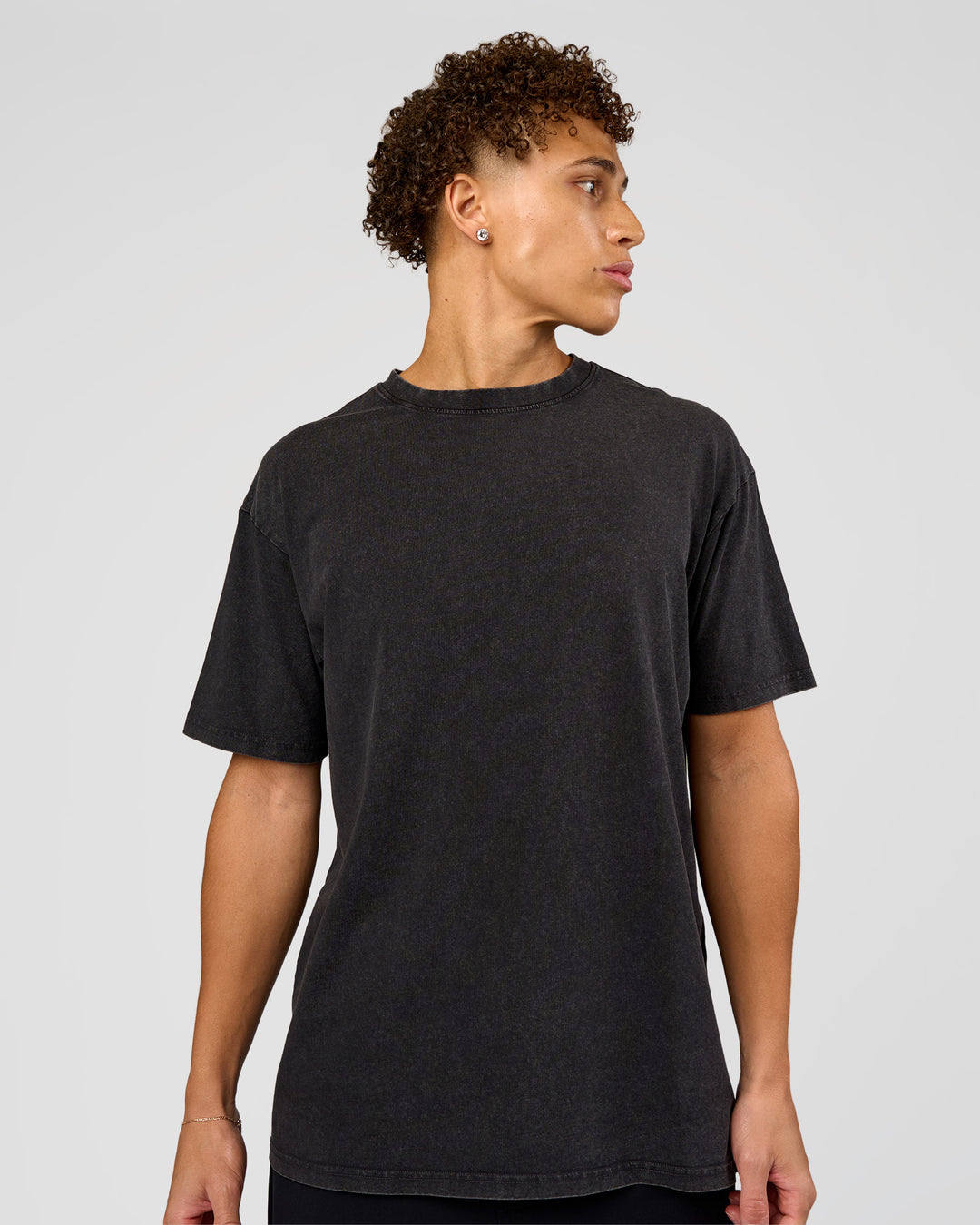 Man wearing Shadow Mode FLXCotton Oversized Tee - Black Washed | Model:Leandro | Size:M