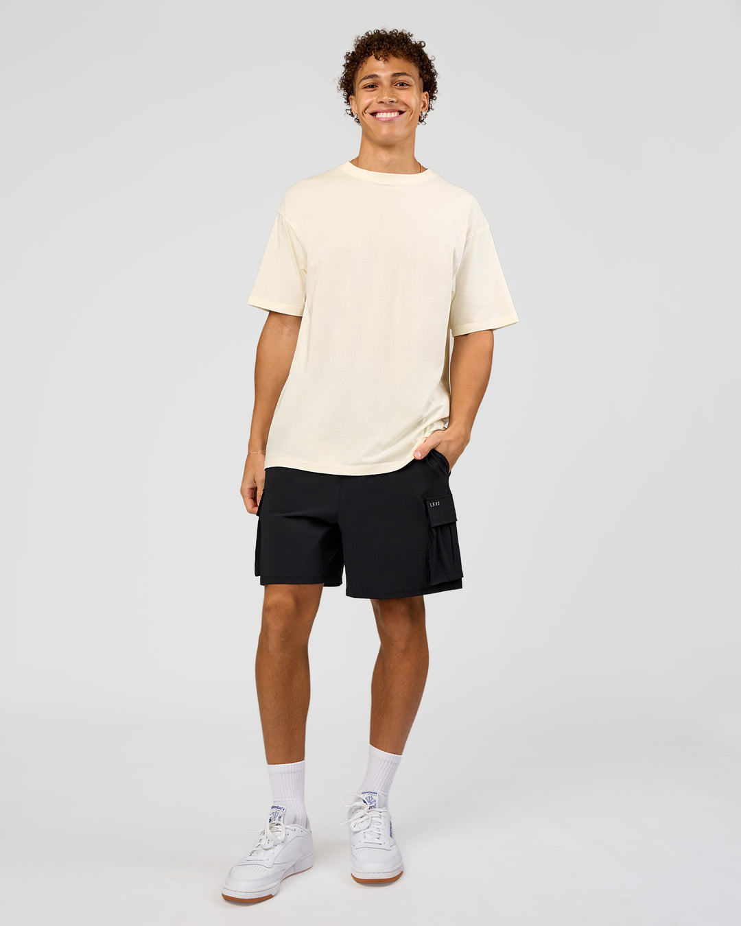 Man wearing Shadow Mode FLXCotton Oversized Tee - Off White Washed | Model:Leandro | Size:M