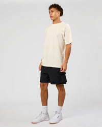 Man wearing Shadow Mode FLXCotton Oversized Tee - Off White Washed | Model:Leandro | Size:M
