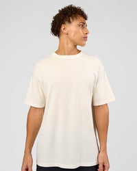 Man wearing Shadow Mode FLXCotton Oversized Tee - Off White Washed | Model:Leandro | Size:M