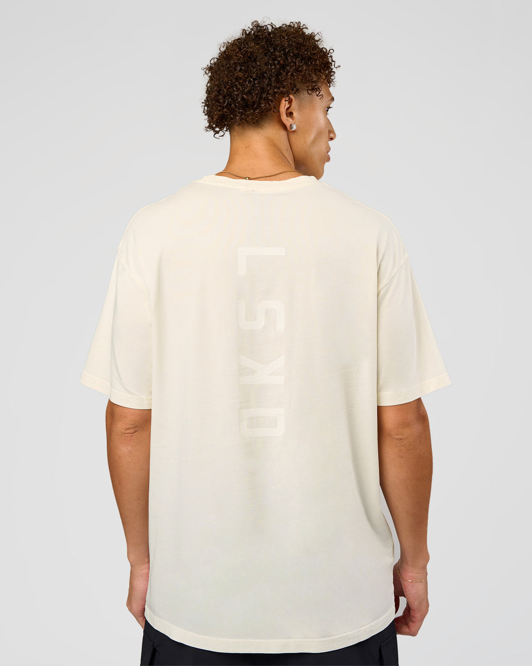 Man wearing Shadow Mode FLXCotton Oversized Tee - Off White Washed | Model:Leandro | Size:M