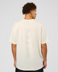 Man wearing Shadow Mode FLXCotton Oversized Tee - Off White Washed | Model:Leandro | Size:M