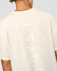Man wearing Shadow Mode FLXCotton Oversized Tee - Off White Washed | Model:Leandro | Size:M