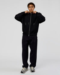 Man wearing Shadow Mode Oversized Zip Through Hoodie - Black | Model:Leandro | Size:M