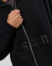 Man wearing Shadow Mode Oversized Zip Through Hoodie - Black | Model:Leandro | Size:M