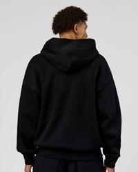 Man wearing Shadow Mode Oversized Zip Through Hoodie - Black | Model:Leandro | Size:M