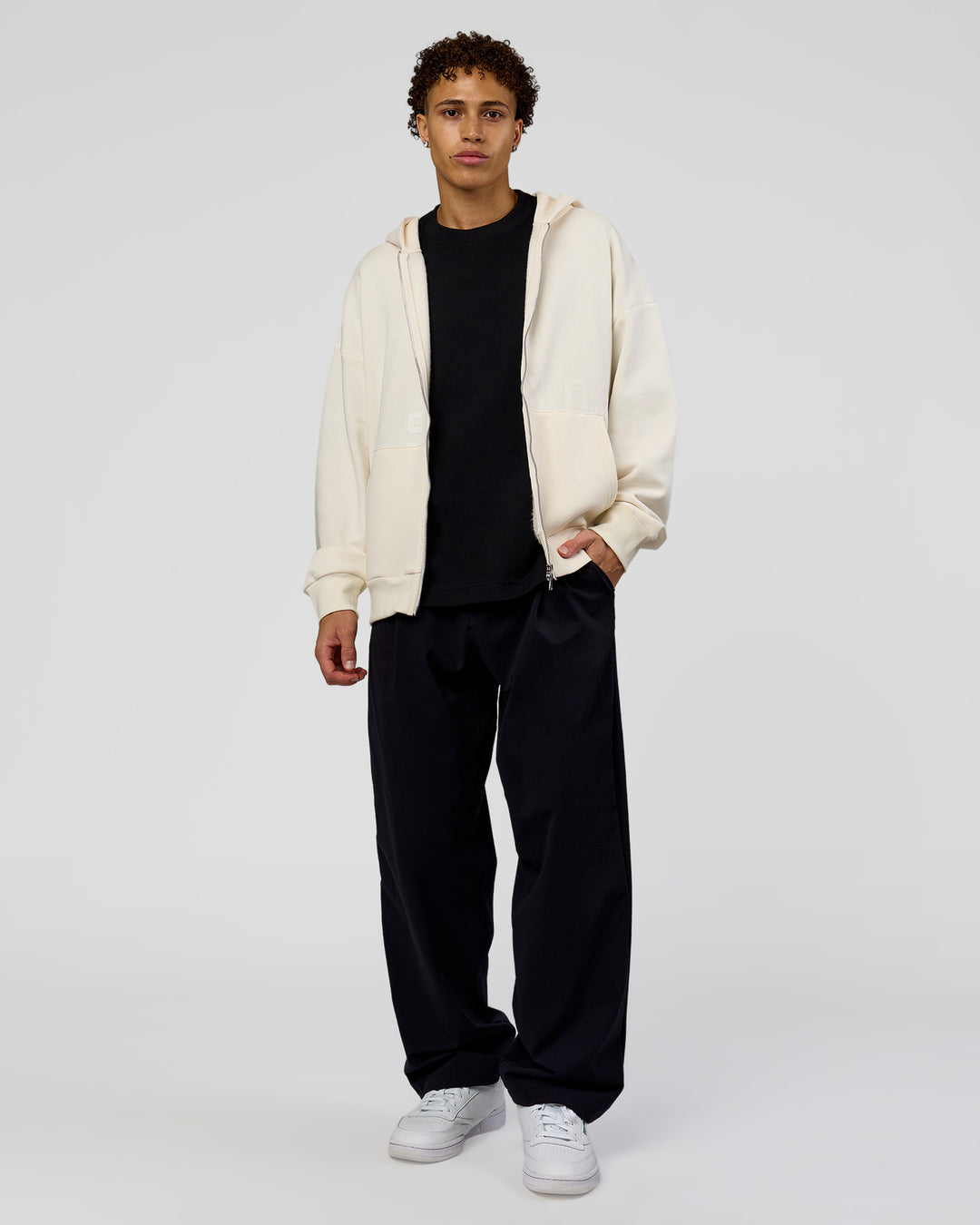 Man wearing Shadow Mode Oversized Zip Through Hoodie - Off White | Model:Leandro | Size:M