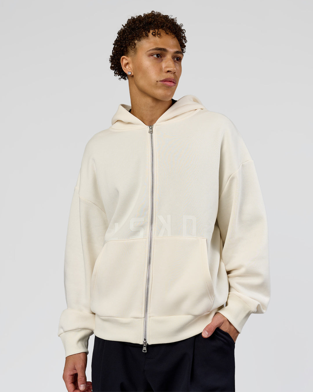 Man wearing Shadow Mode Oversized Zip Through Hoodie - Off White | Model:Leandro | Size:M