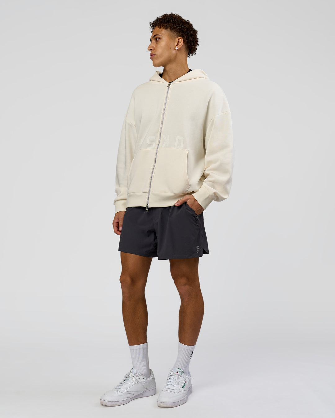 Man wearing Shadow Mode Oversized Zip Through Hoodie - Off White | Model:Leandro | Size:M