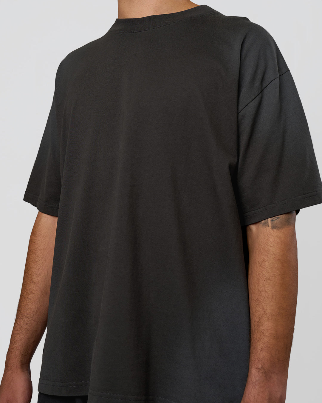 Man wearing Spray Heavyweight Unisex Oversized Tee - Charcoal Washed | Model:Zoran | Size:M