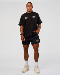 Man wearing Static Grit Heavyweight Oversized Tee - Black-Alloy | Model:Malebo | Size:M
