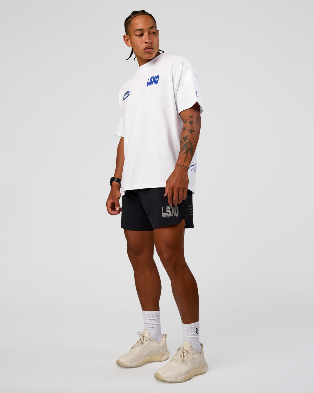 Man wearing Static Grit Heavyweight Oversized Tee - White-Electric Indigo | Model:Malebo | Size:M