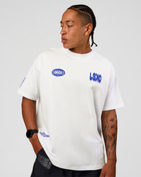 Man wearing Static Grit Heavyweight Oversized Tee - White-Electric Indigo | Model:Malebo | Size:M