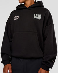 Man wearing Static Grit Unisex Boxy Hoodie - Black-Alloy | Model:Malebo | Size:M