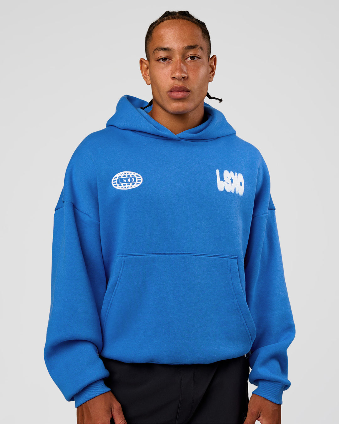 Man wearing Static Grit Unisex Boxy Hoodie - Palace Blue-White | Model:Malebo | Size:M