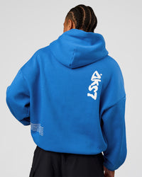 Man wearing Static Grit Unisex Boxy Hoodie - Palace Blue-White | Model:Malebo | Size:M