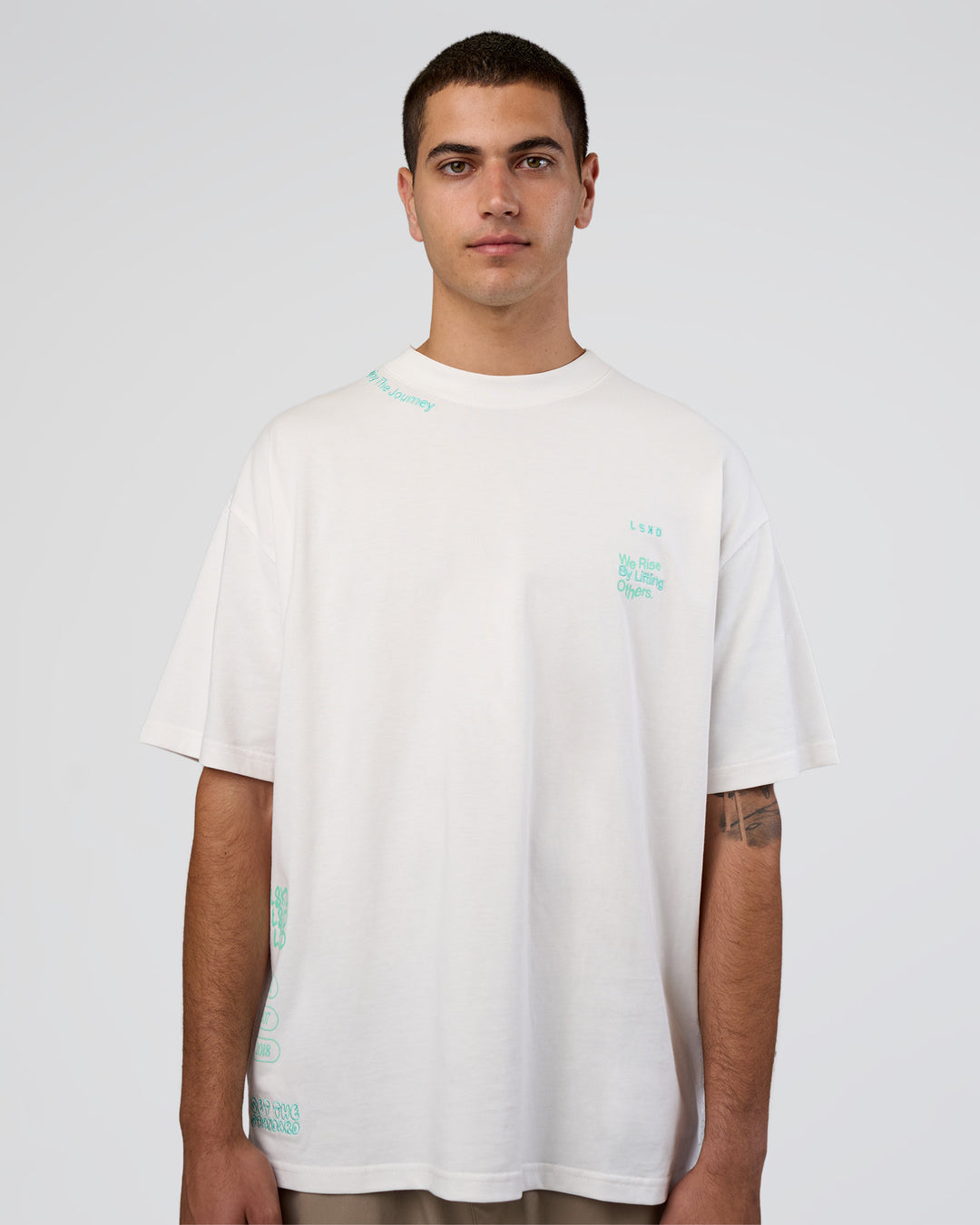 Man wearing Sticker Heavyweight Oversized Tee - Off White-Jelly Mint | Model:Zoran | Size:M