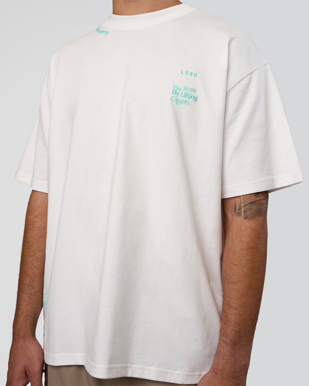 Man wearing Sticker Heavyweight Oversized Tee - Off White-Jelly Mint | Model:Zoran | Size:M