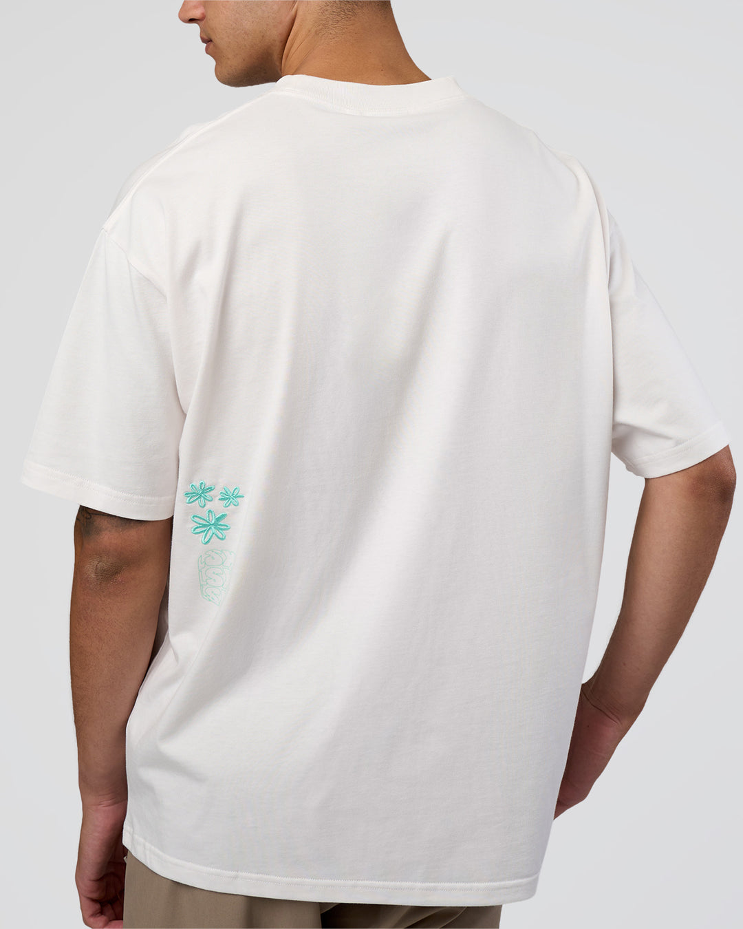 Man wearing Sticker Heavyweight Oversized Tee - Off White-Jelly Mint | Model:Zoran | Size:M