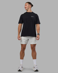 Man wearing Today's Run FLXCotton Oversized Tee - Black-White | Model:Jaiden | Size:M