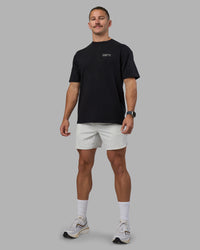 Man wearing Today's Run FLXCotton Oversized Tee - Black-White | Model:Jaiden | Size:M