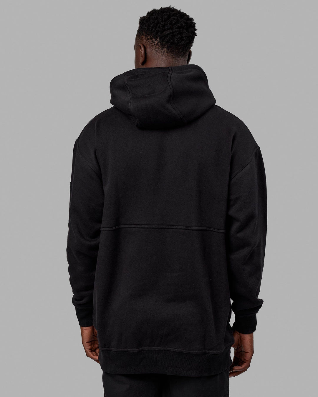 Man wearing Unisex Trek Hoodie Oversize - Black