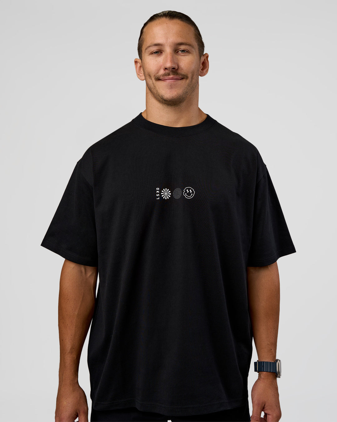 Man wearing Trust The Process Heavyweight Unisex Oversized Tee - Black-White | Model:Jaiden | Size:M