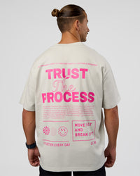 Man wearing Trust The Process Heavyweight Unisex Oversized Tee - Digital Mist-Ultra Pink | Model:Jaiden | Size:M