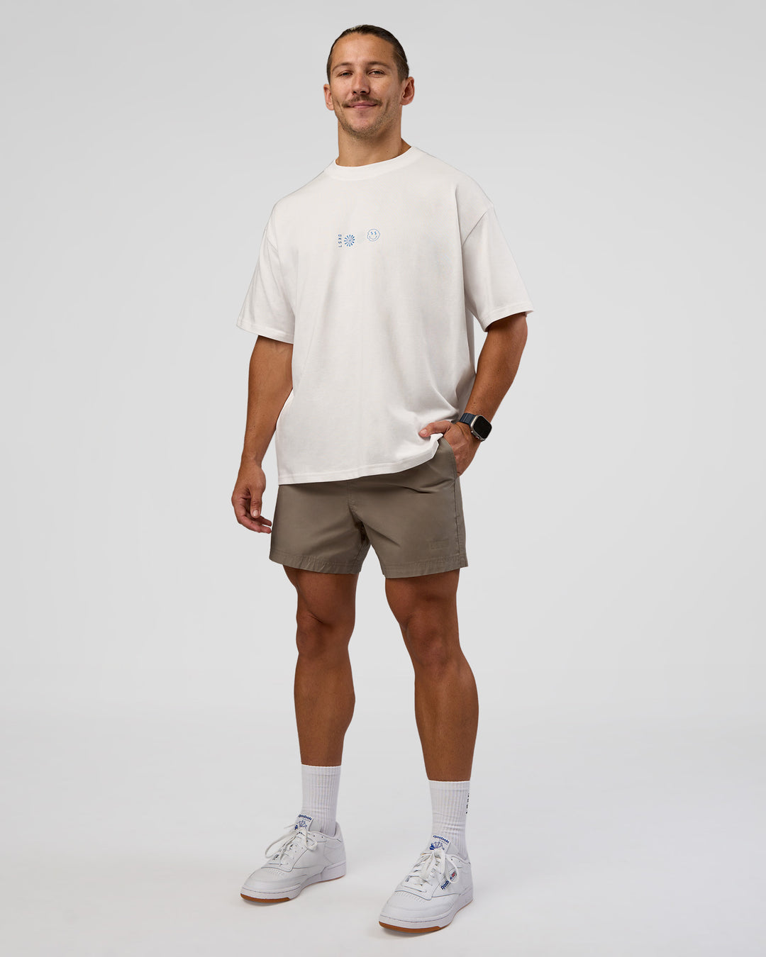 Man wearing Trust The Process Heavyweight Unisex Oversized Tee - Off White-Electric Indigo | Model:Jaiden | Size:M
