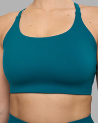 Woman wearing Twist Sports Bra D/DD/E - Blue Coral | Model:Amy | Size:M