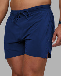 Man wearing UltraAir 5" Lined Performance Short - Midnight Blue | Model:Jaiden | Size:M