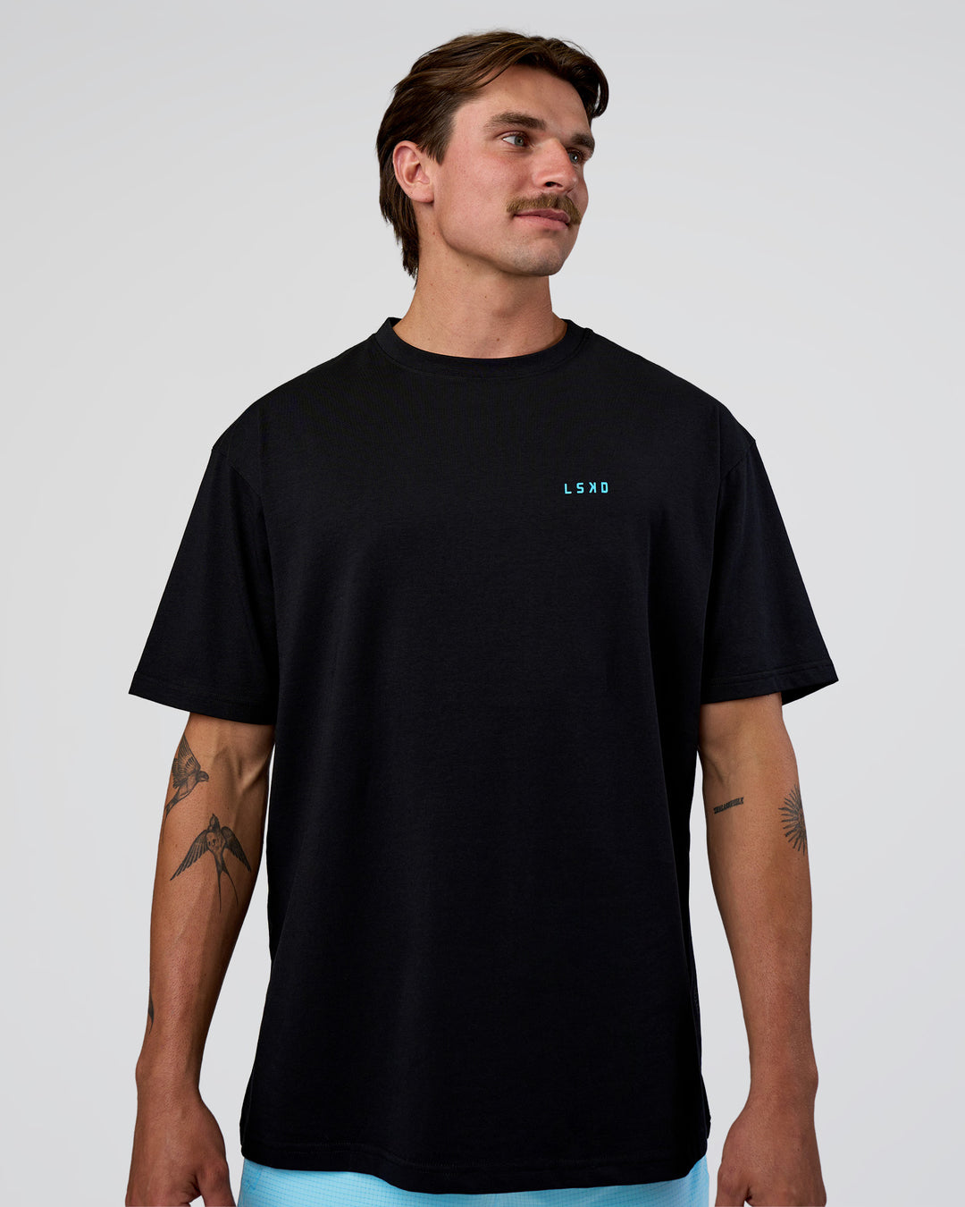 Man wearing Unfit Club FLXCotton Oversized Tee - Black-White | Model:Konnor | Size:M