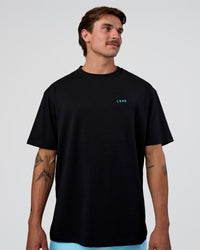 Man wearing Unfit Club FLXCotton Oversized Tee - Black-White | Model:Konnor | Size:M