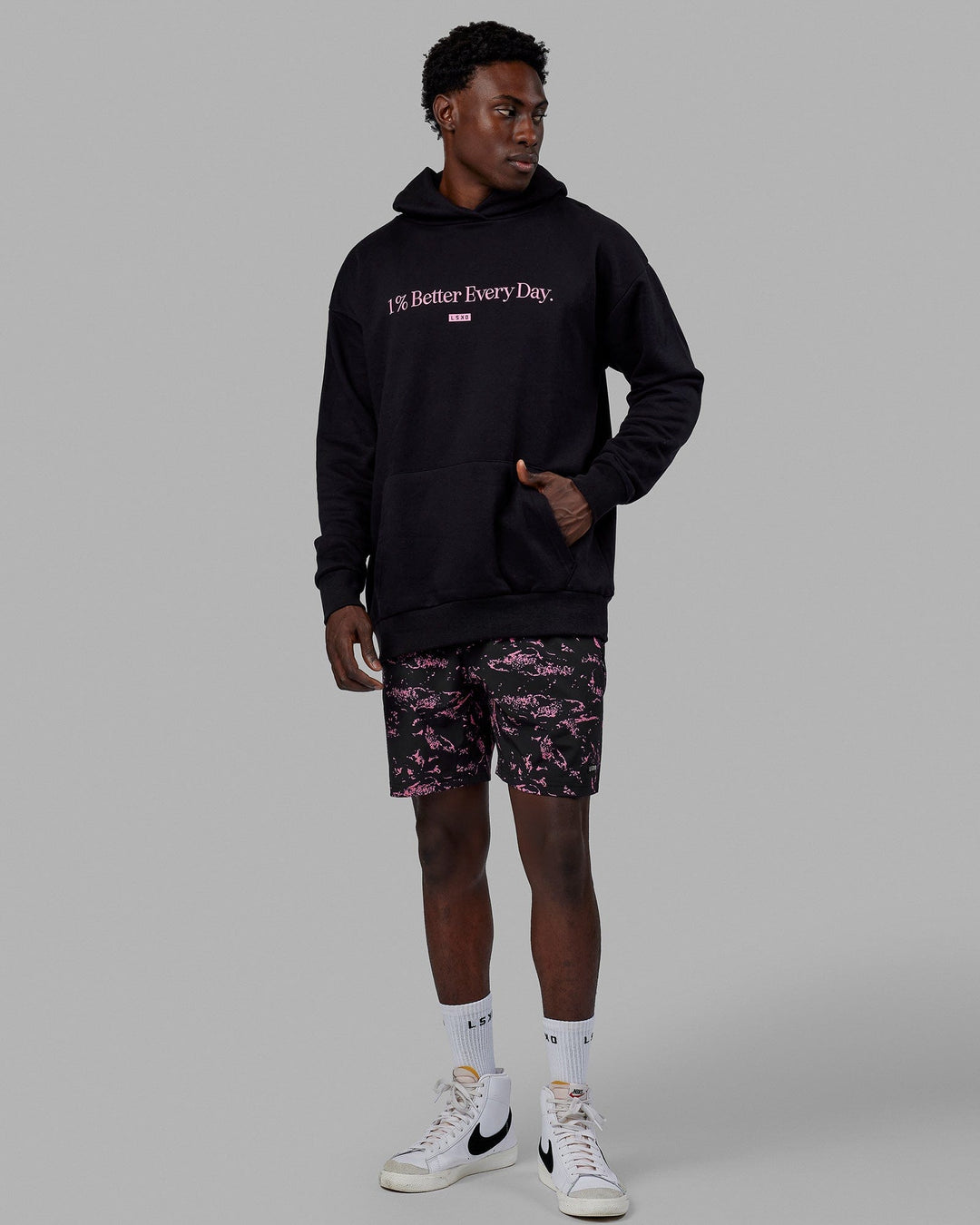 Man wearing Unisex 1% Better Hoodie Oversize - Black-Pink Rose