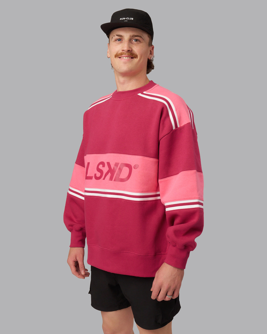 Man wearing A-Team Sweater Oversize - Vivacious-Hot Pink | Model:Isaac | Size:M