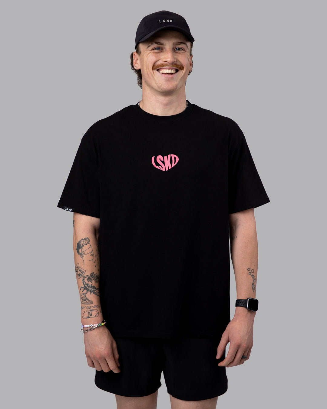 Man wearing Unisex Love To Train FLXCotton Tee Oversize in Black-Pink Lemonade | Size:M
