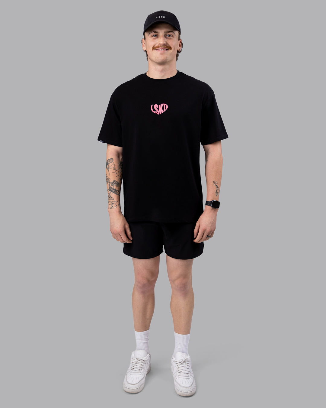 Man wearing Unisex Love To Train FLXCotton Tee Oversize in Black-Pink Lemonade | Size:M