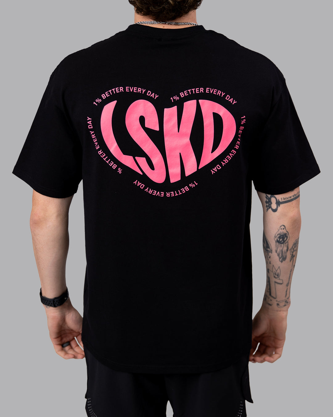 Man wearing Unisex Love To Train FLXCotton Tee Oversize in Black-Pink Lemonade | Size:M
