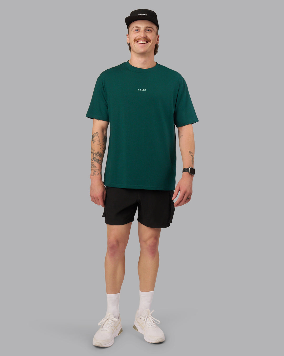 Man wearing On Repeat FLXCotton Oversized Tee - Dark Moss-Ice Green | Model:Isaac | Size:M