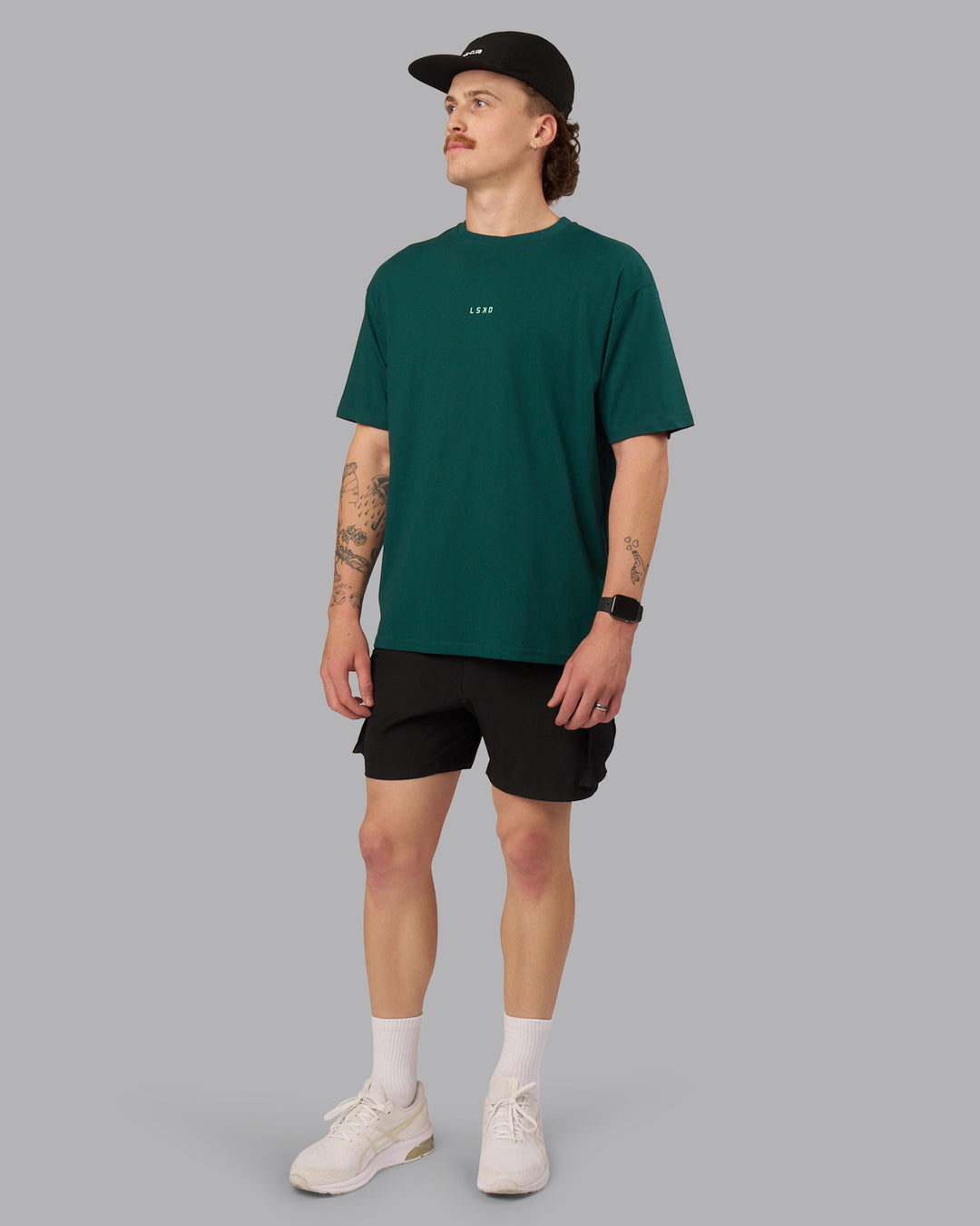 Man wearing On Repeat FLXCotton Oversized Tee - Dark Moss-Ice Green | Model:Isaac | Size:M