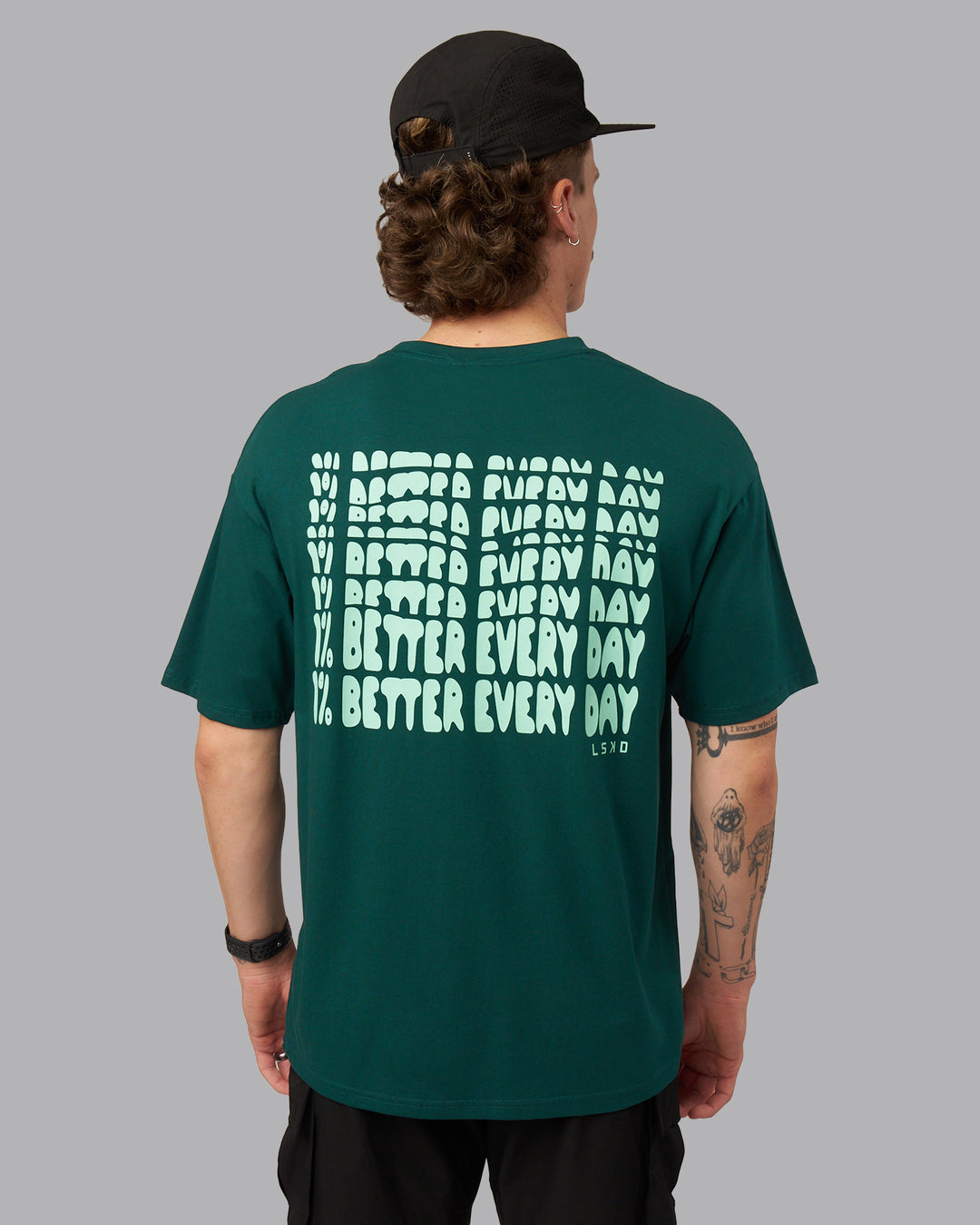Man wearing On Repeat FLXCotton Oversized Tee - Dark Moss-Ice Green | Model:Isaac | Size:M