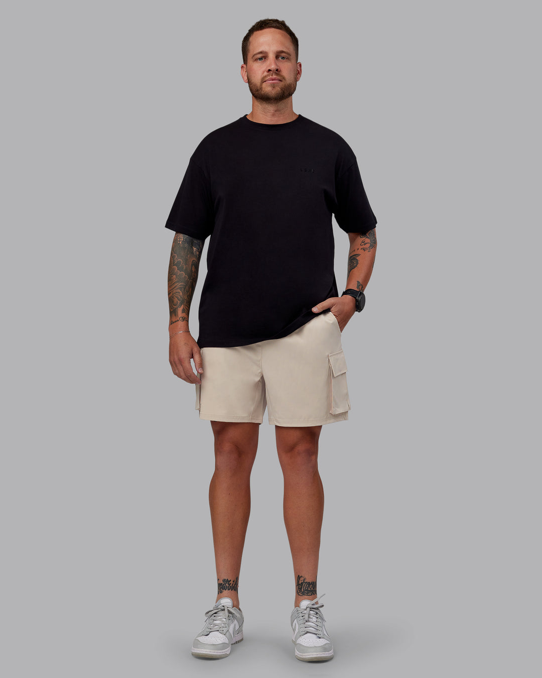 Man wearing Unisex PimaFLX Tee Oversize - Black | Model:Macca | Size:M